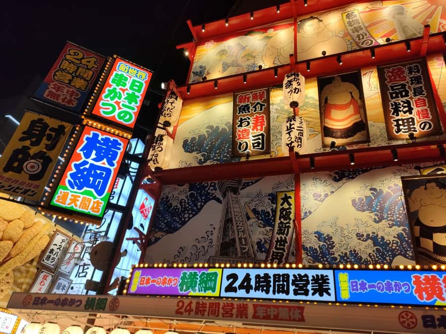 Neon signboards reflected in the Dotonbori canal after dark