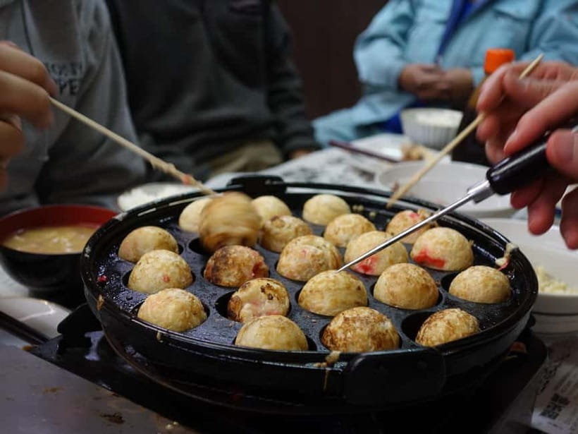 Osaka: Food Tour Kuromon Market & Dotonbori with Guide - Hozenji brings a quieter change of pace