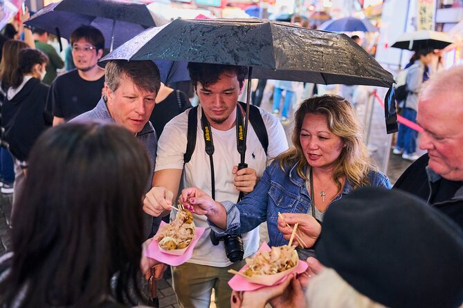 Osaka: Guided Food Tour with 12 Dishes at 4 Local Eateries - From dumplings and takoyaki to izakaya plates